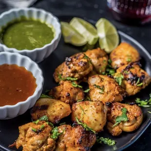 a plate of chicken wings and dipping sauce