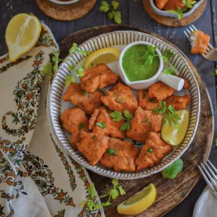 a plate of chicken skewers