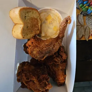 a fried chicken and a side of bread