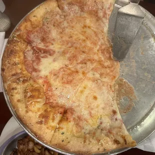 Extra cheese pizza with side of roasted garlic