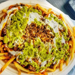 a plate of fries and guacamole