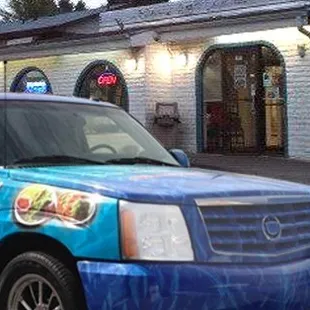 a truck parked in front of a restaurant
