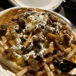 Chili cheese fries with chicarrons  and sour cream