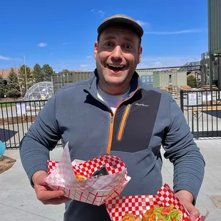 a man holding two baskets of food