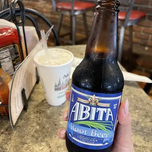 a person holding a bottle of beer