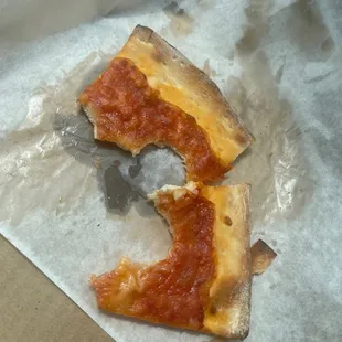 Two super small slices no cheese no sauce completely old. Resembles cafeteria pizza taste that way also.