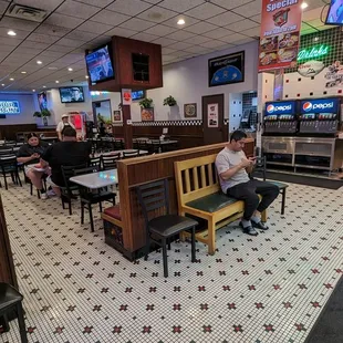 a man sitting on a bench in a restaurant