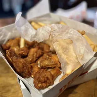  a basket of fried chicken and french fries