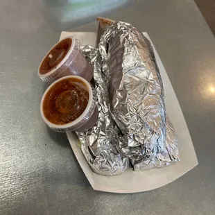 a burrito and condiments