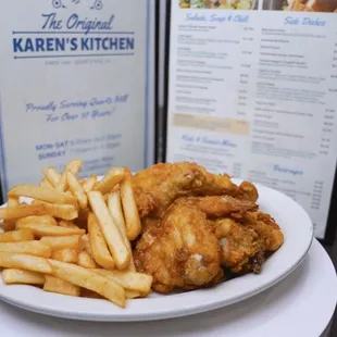 a plate of fried chicken and french fries