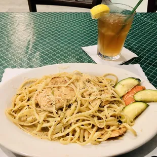a plate of pasta and a drink