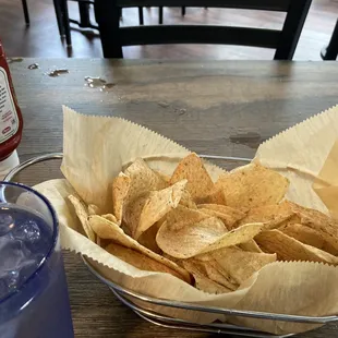 a basket of chips and a drink