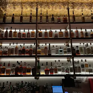 a shelf of liquor bottles