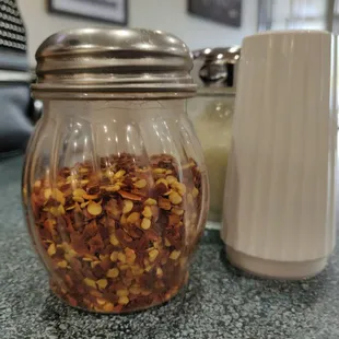 a jar of nuts and a salt shaker