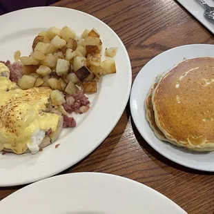 Eggs Benedict with a side of Homestyle Potatoes and pancakes