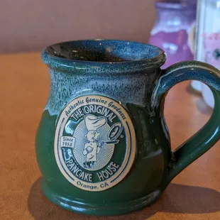 a green mug on a table