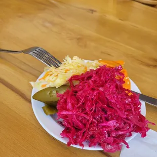 a plate of sauerkraut and pickles