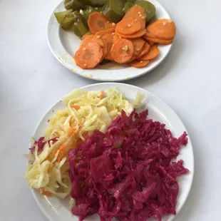 two plates of sauerkraut and carrots