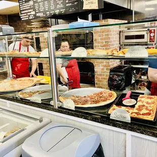 a group of people in a pizza shop