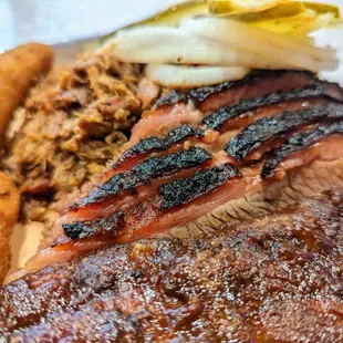 Close-up of Chili-Rubbed Beef Brisket, sliced. Part of our Three Meat Combo. $22.95.