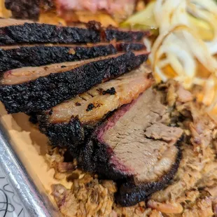 Close-up of Chili-Rubbed Beef Brisket, sliced. Part of our Three Meat Combo. $22.95.