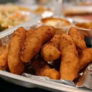 Close-up of hush puppies. They&apos;re really good. Side to a plate.