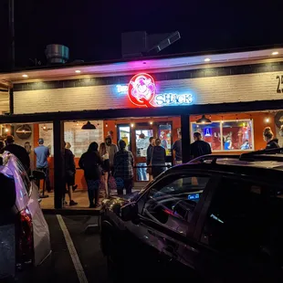 Outside. Storefront at night. Line outside to order on a Saturday evening.