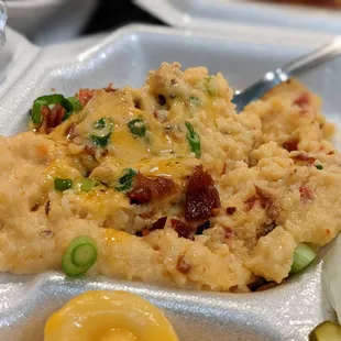 Close-up of special jalapeno cheddar grits. Side to a plate.