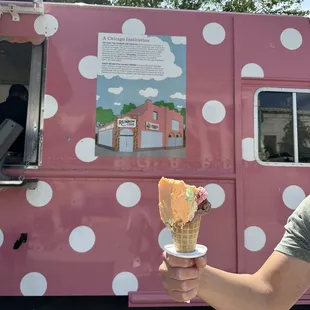 a woman holding an ice cream cone