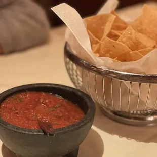 a bowl of chips and a bowl of salsa