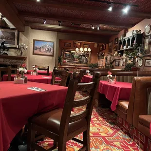 a dining room with red tablecloths