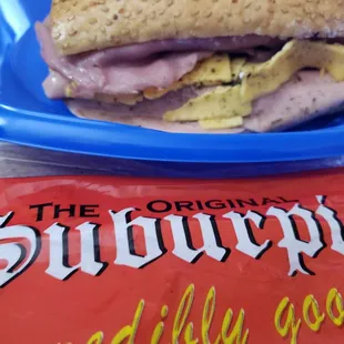 Closer shot of the sandwich with wrapper...to go order.