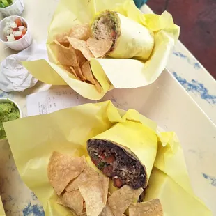Veggie Burrito in foreground, shredded chicken burrito in background