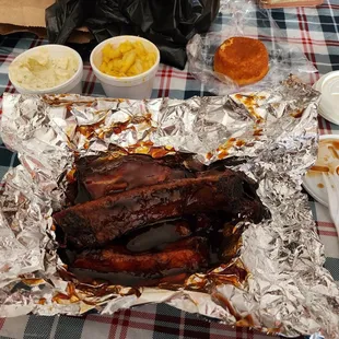 BBQ Pork dinner plate with potato salad man and cheese and corn bread.