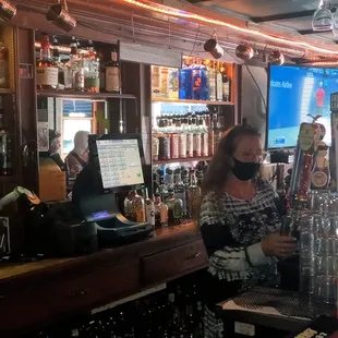 a woman behind the bar