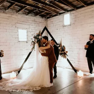 Warehouse vibes with beautiful ceremony backdrop
