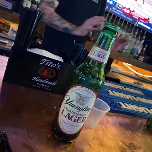 a man at a bar with a beer