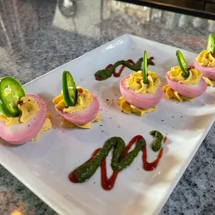 Deviled eggs with jalapeño, pesto and sriracha...great flavor and a spicy kick!