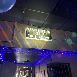 a sign that reads please don&apos;t go to the bathroom