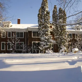 a snow - covered driveway in front of the lodge