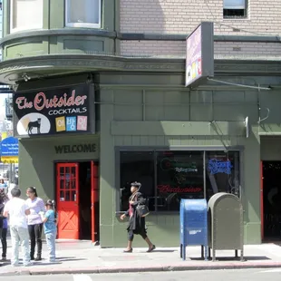 a group of people standing outside of a building
