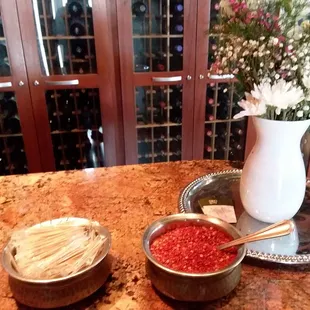 two bowls of food and a vase of flowers