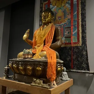 a statue of a buddha sitting on a table