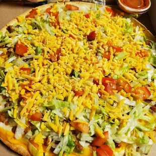 a pizza in a box with toppings