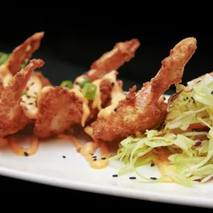 a plate of fried shrimp and salad