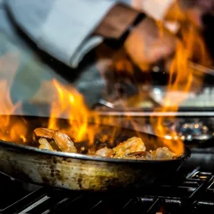 a chef cooking food on a grill