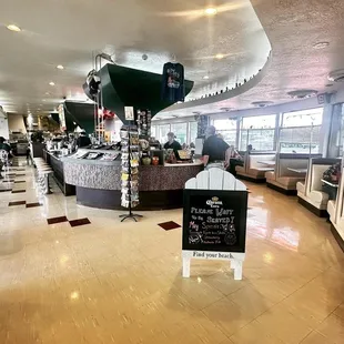 a bar with a sign in front of it