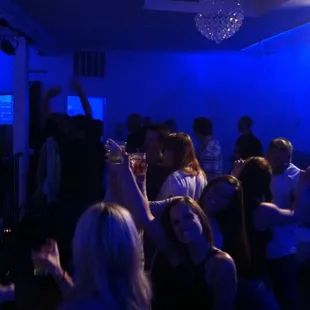 a group of people in a blue lit room