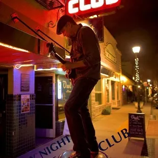 a man standing on top of a trashcan