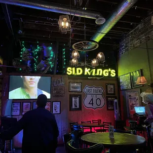 a man standing in front of a large screen